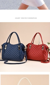 Detail of diamond-quilted PU leather handbags in navy and red with gold hardware