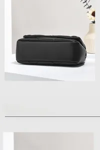 Detail of black quilted leather mini bag with high-end texture and structured design