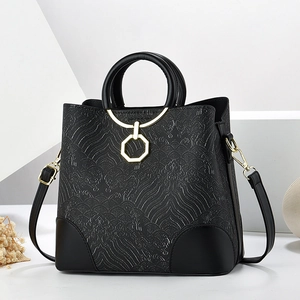 Black vintage-style crossbody bag with textured cloud pattern and gold hardware