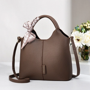 Fashionable brown pebbled leather handbag with top handle and silk scarf detail