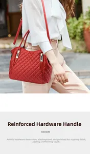 Detail showing the reinforced golden hardware and polished handle on the red quilted handbag