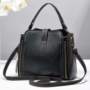 Chic black and brown patchwork bucket bag with lychee texture and checkerboard pendant