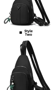 Close-up of black waterproof nylon chest bag with silver zippers and a star charm