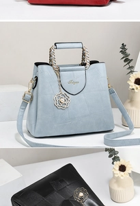Detail of geometric patchwork handbag with pearl flower charm and metal chain handle