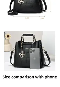 Detailed size guide of black lychee leather handbag compared with a smartphone