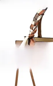 Detailed view of bicolor tote bag with scarf-wrapped handle and golden hardware