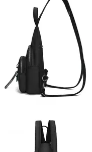 Detail view of black nylon chest bag showing side profile and silver metal zipper layers
