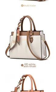 Detail of two-tone tote bag with metal logo, printed scarf wrap and shoulder strap