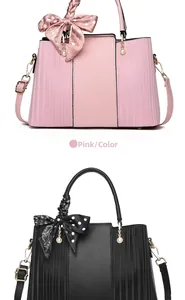 Detail of pink and black tote bags with pleated sides, pearl charms, and silk handle scarves