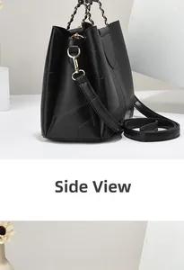 Detailed side view of black patchwork leather handbag with gold chain and crossbody strap