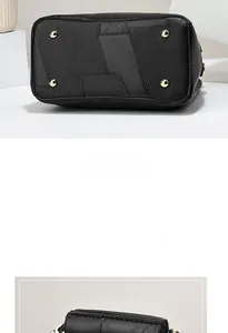 Detail view of black textured leather bag bottom with four protective gold metal feet