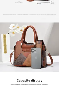 Detail view of color-block tote bag showing dimensions 27cm x 12cm with chic top handle