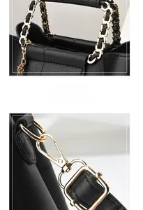 Detailed view of woven metal chain handle and gold hardware on black leather handbag