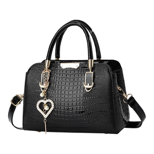 Fashionable black crocodile pattern handbag with golden hardware and pearl heart charm