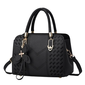Classic black leather tote bag with V-shaped embroidery and butterfly pendant
