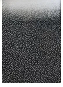 Detail of black faux leather with elegant crocodile texture and polished finish