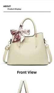 Close-up of beige lychee texture handbag with gold hardware and floral scarf detail