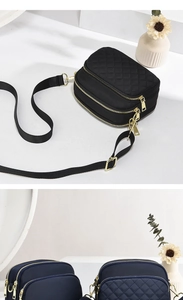 Detail of the multi-layer golden zippers and quilted texture on the casual crossbody bag