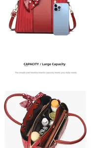 Macro view of red textured leather handbag showing spacious multi-layer inner compartments