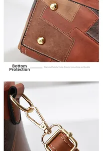 Detail view of anti-wear metal studs on bag bottom and durable golden strap hooks