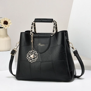 Elegant black leather handbag with chain handle and floral pearl charm for daily commute