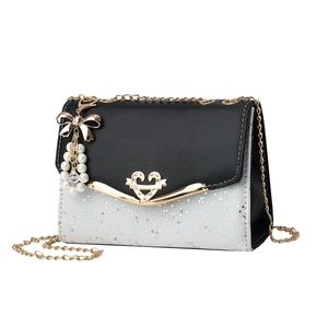 Quilted crossbody bag with heart lock, gold chain, and pearl bow charm in black and silver