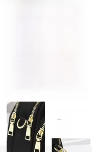 Detailed shot of black nylon bag with gold hardware, headphone port and dual zippers