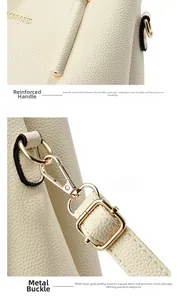 Close-up of litchi grain leather bag with gold-plated metal buckles and sturdy handles