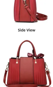 Detail view of red textured leather handbag with side profile and gold hardware accents