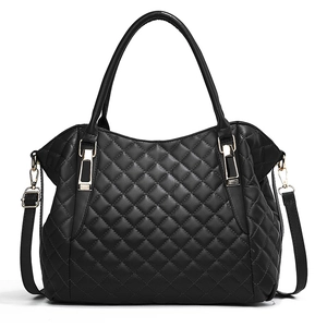 Black quilted faux leather tote bag with gold hardware and removable shoulder strap