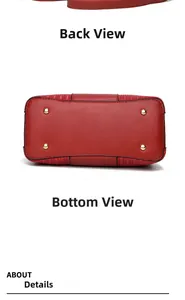 Detail view of red leather handbag showing the back and bottom with protective gold feet