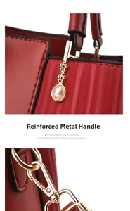 Detail of red leather handbag showing gold hardware, pearl accents, and reinforced handles