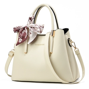 Elegant cream leather tote with printed silk scarf handle and gold hardware detail