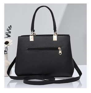 Detailed macro of black lychee grain texture with heart-shaped zipper and gold hardware