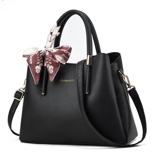 Elegant black lychee leather handbag with printed silk scarf and gold hardware accents