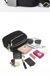 Detail view of the large storage capacity with multiple zippered layers and daily items
