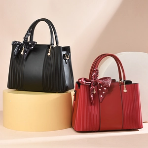 Elegant handheld bags in red and black with pleated sides and silk scarf decoration