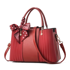 Elegant wine red handbag with pleated panels, silk scarf, and pearl charm for women