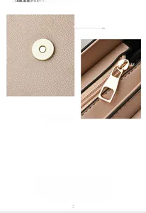 Detail of beige lychee leather pattern with MQCKH logo and gold magnetic snap closure