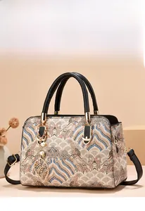 Detail of vintage beige floral jacquard fabric with premium black leather strap and gold leaf charm
