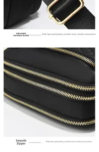 Detail of premium gold hardware with smooth dual zippers on black nylon shoulder bag