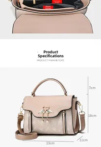Internal zipper pocket and swan buckle detail of pink leather handbag with measurements