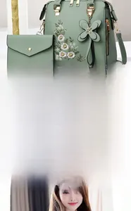Detail view of sage green 2-piece handbag set with delicate floral embroidery and hardware