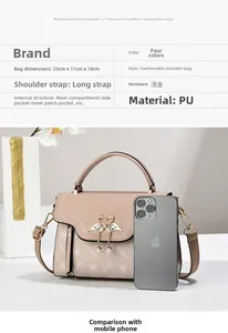 Detailed view of the khaki PU leather handbag featuring a crystal swan charm and dimension info