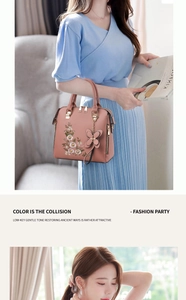 Detail of pink faux leather handbag with floral embroidery and butterfly pendant charm