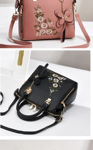 Detail of floral embroidery on solid color PU leather handbags with golden zippers