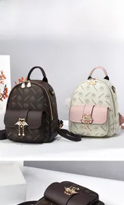 Detail of quality cowhide mini backpack with swan metal buckle and brand logo pattern