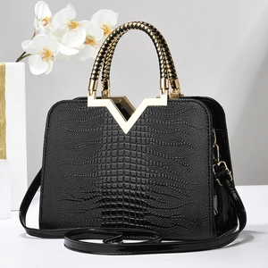 Sac à main noir à motif crocodile avec fermoir V doré et poignée tressée élégante