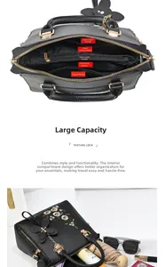 Detail of black embroidered tote bag showing large capacity and internal compartments