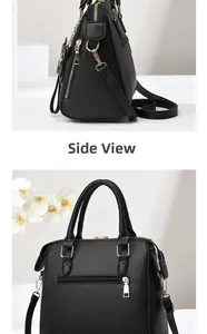 Side view detail of black faux leather handbag with gold zippers and detachable strap